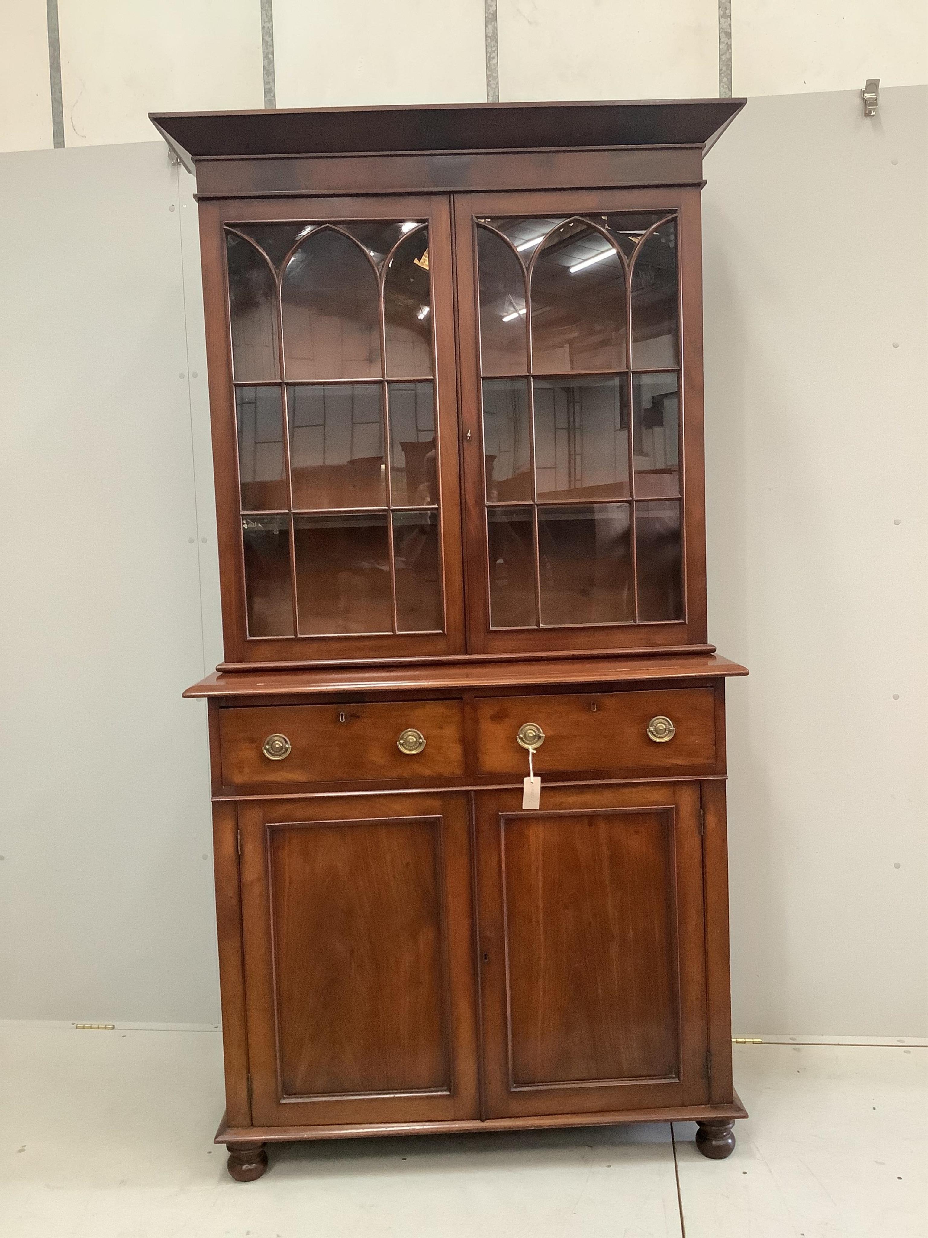 A George III and later mahogany bookcase cupboard, width 115cm, depth 49cm, height 221cm. Condition - good